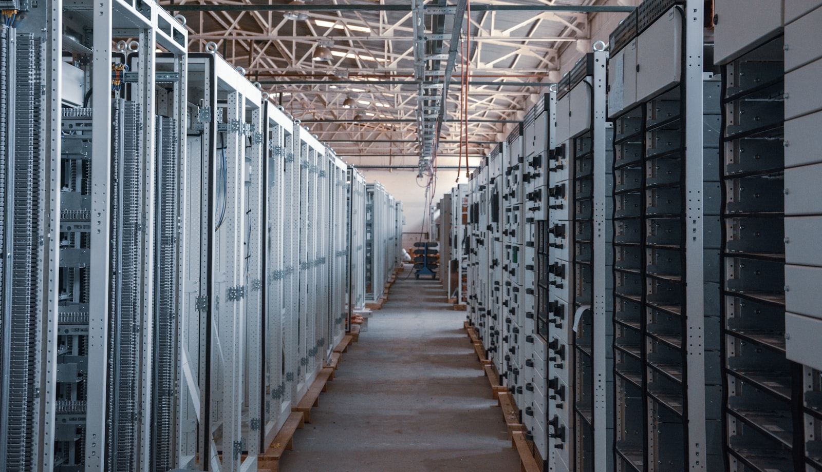 Server room aisle with rows of enterprise equipment racks