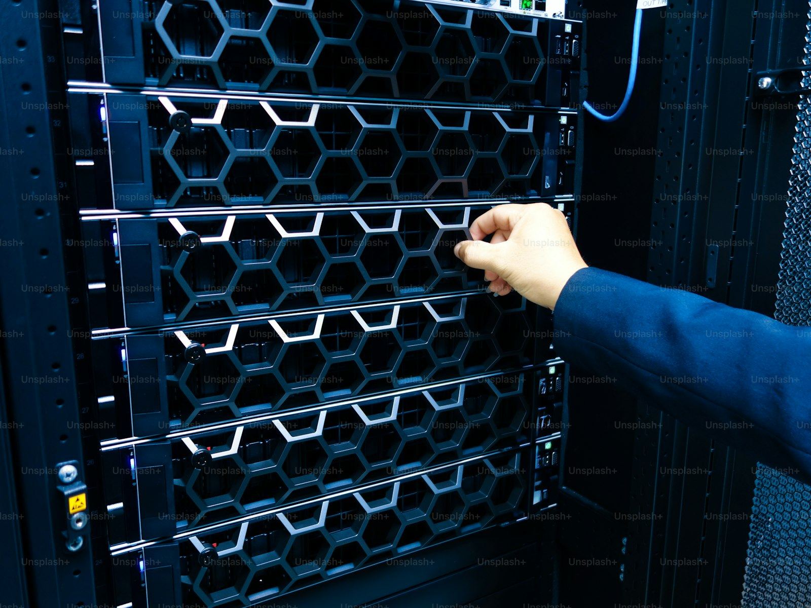 Engineer adjusting an enterprise server inside a data center rack
