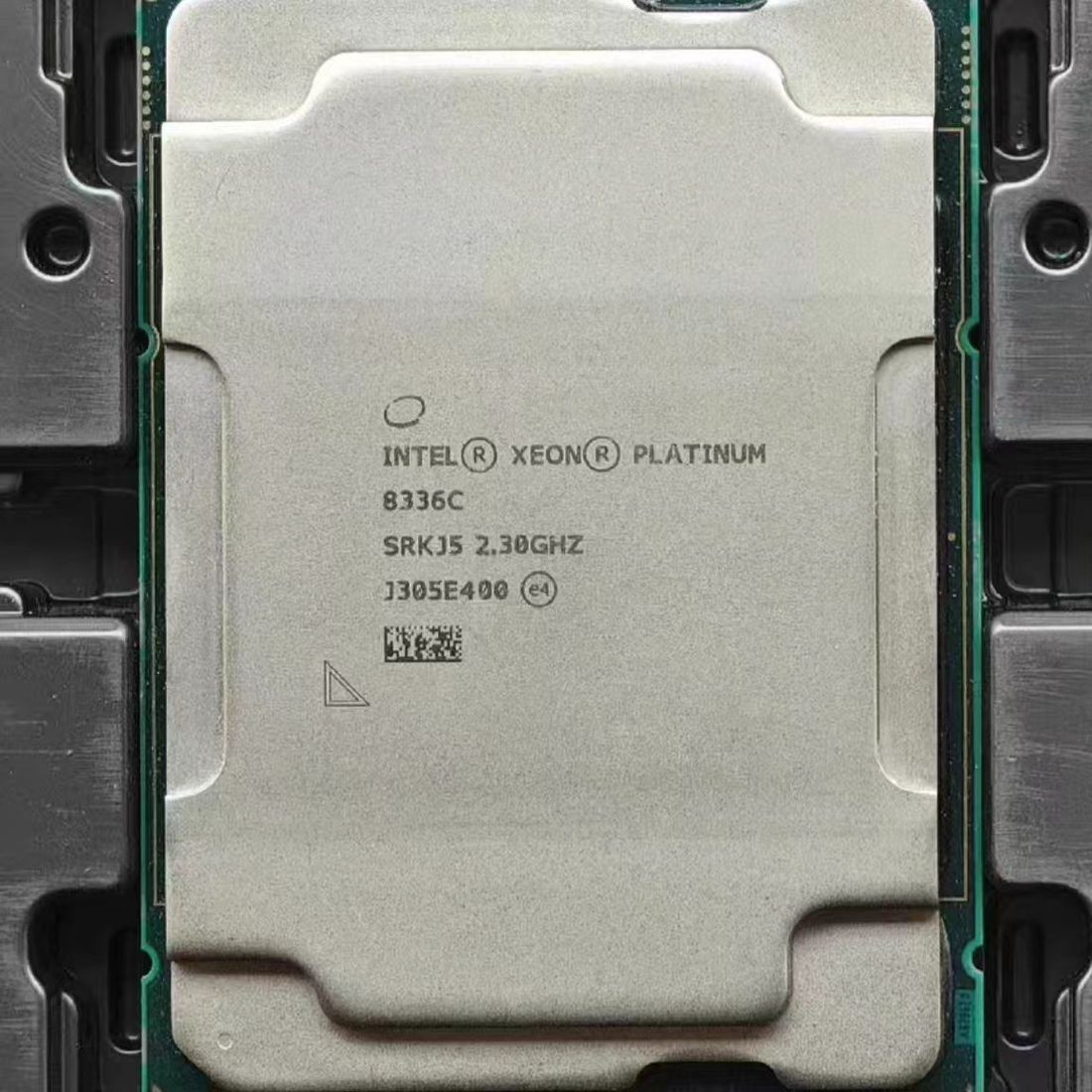 Intel Xeon Platinum processor, top face, laser-etched markings - photographed on a plain surface