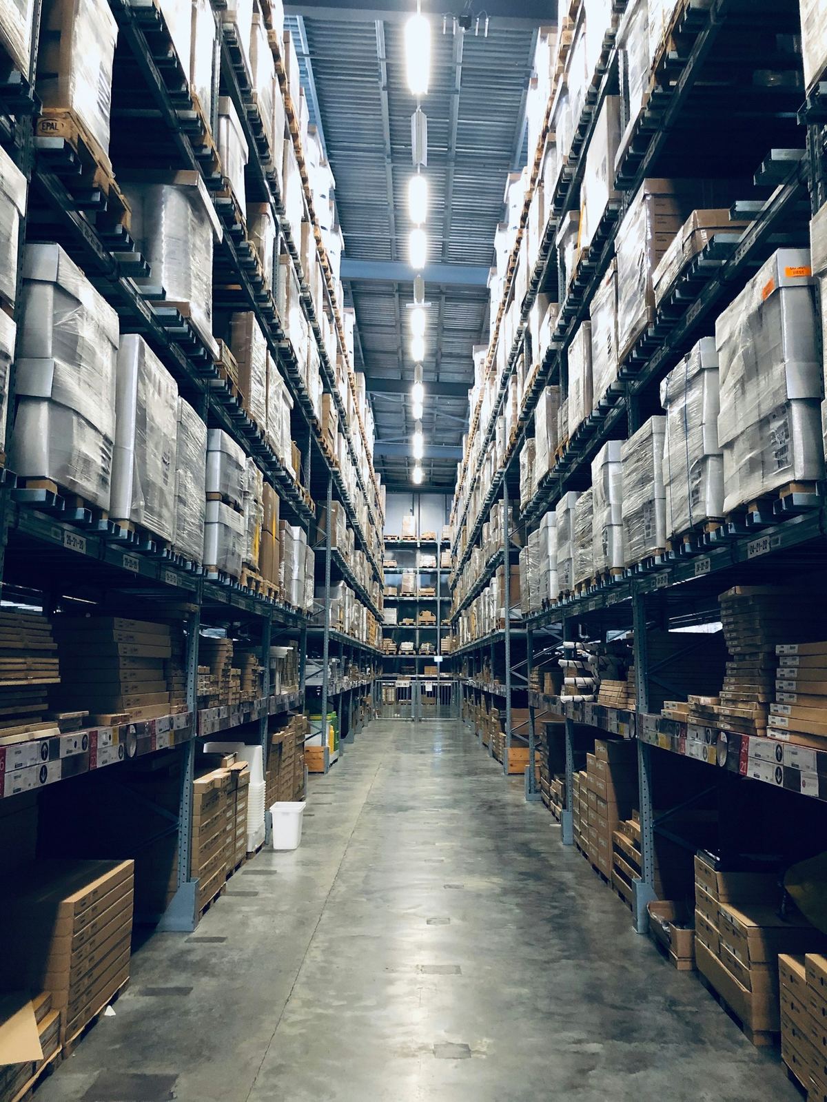 Warehouse aisle with palletized equipment ready for consolidation and export